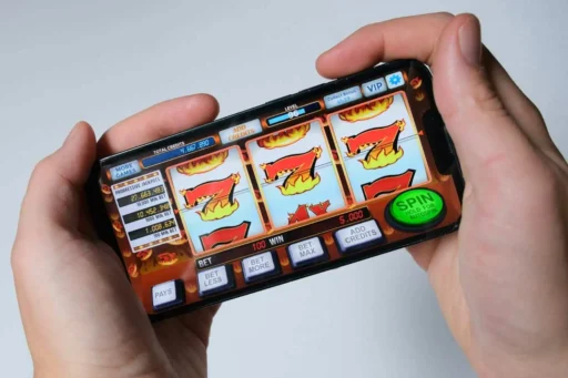 Person playing online slots on a mobilephone