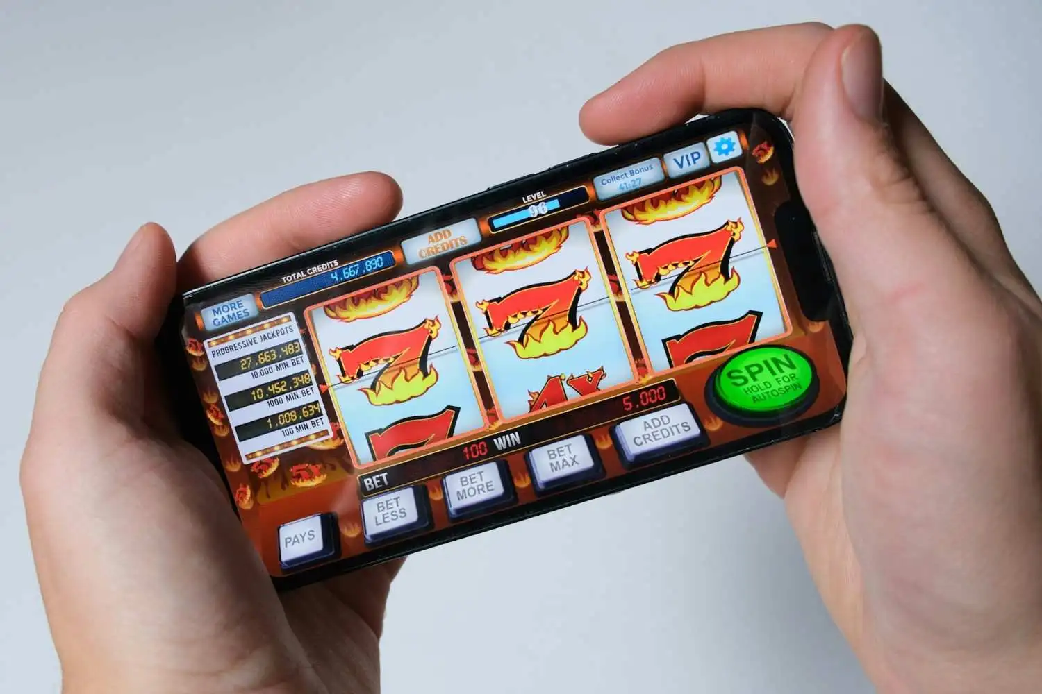 Person playing online slots on a mobilephone